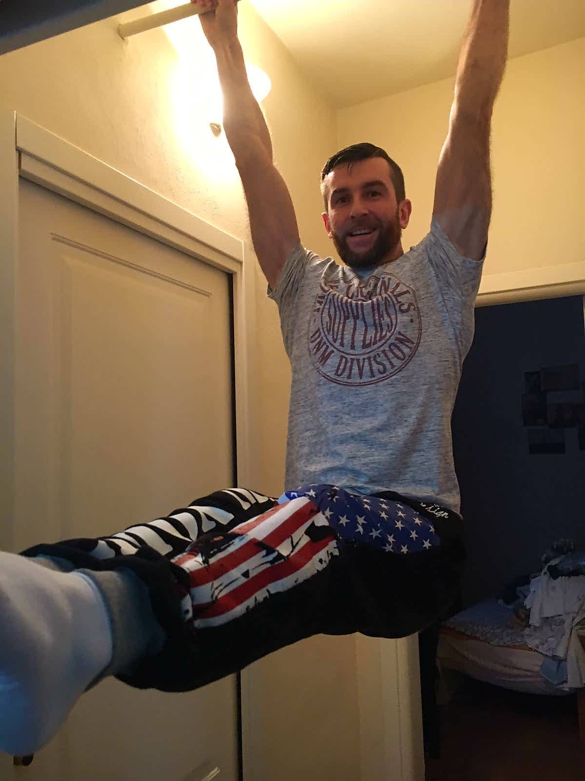 Hanging straight-leg raise from a doorway bar.